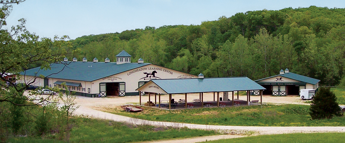 distance view of the ranch signage with Longmeadow Learning Center in background