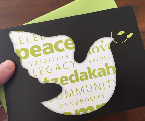 holiday card showing dove and words like peace and tzedakah
